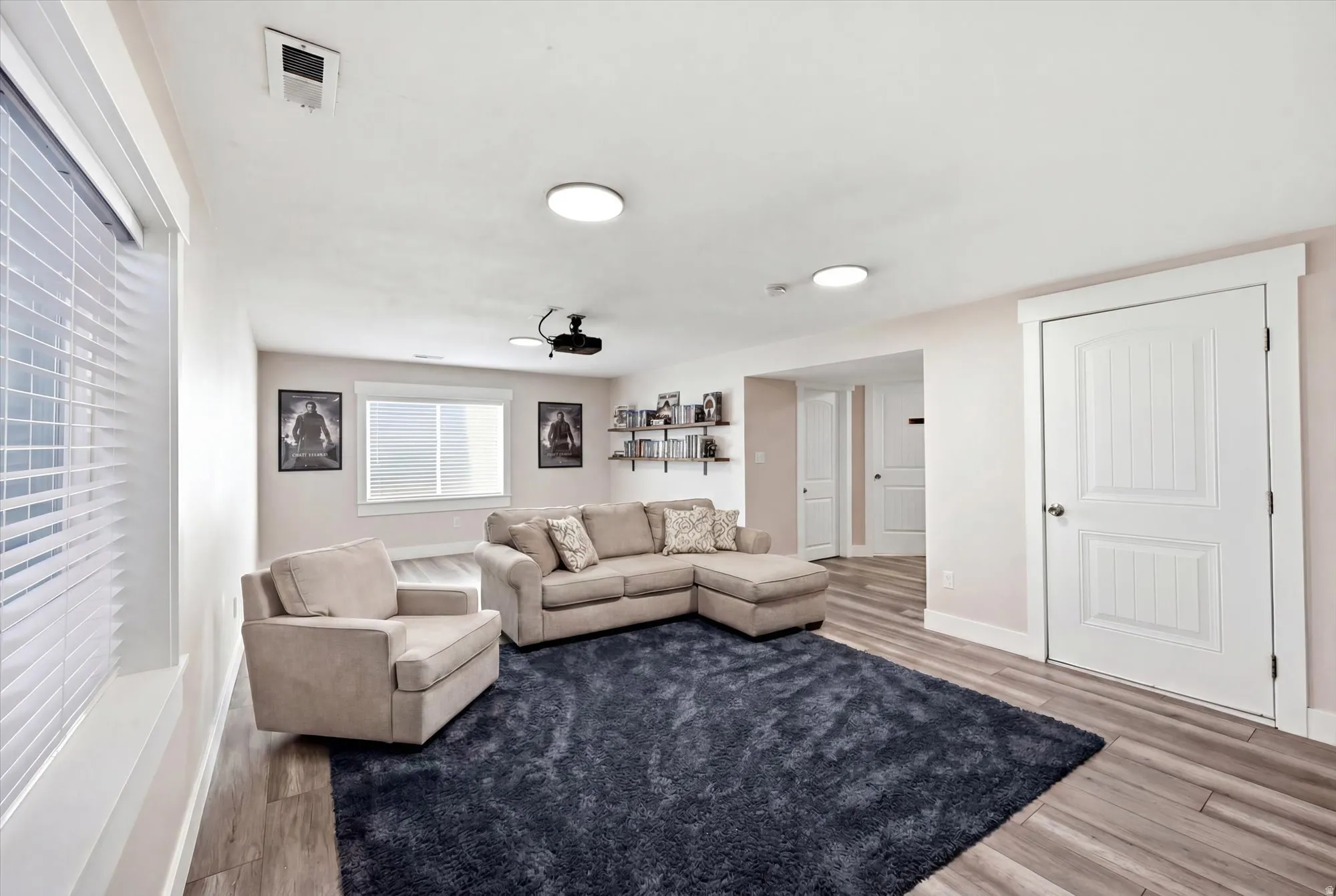 Living area featuring wood-finish flooring and recessed ceiling lights