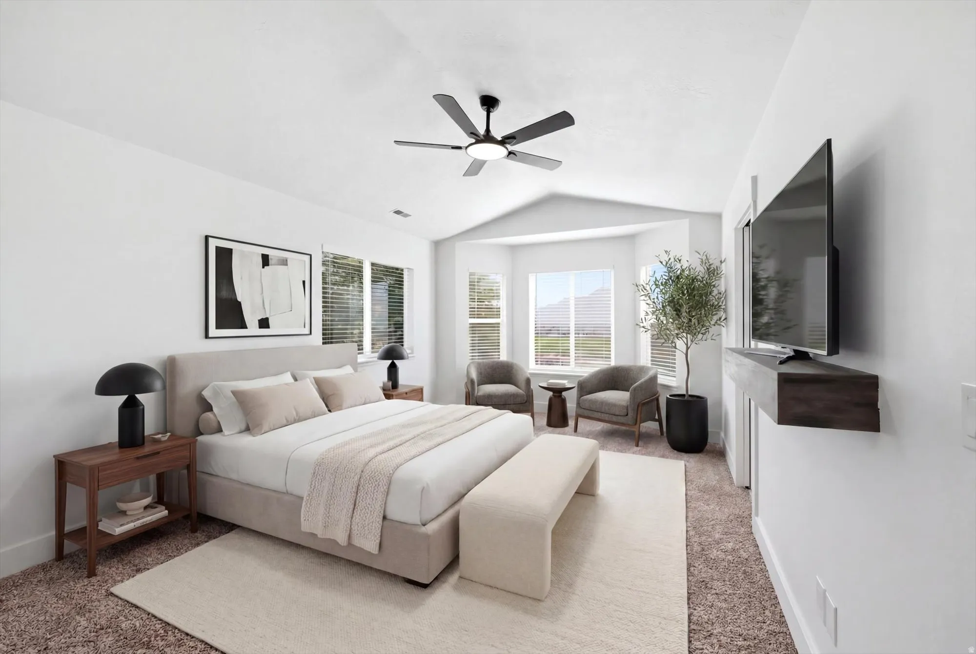 Vaulted ceiling bedroom featuring a modern ceiling fan, bay window with mountain scenery, and built-in floating media shelf