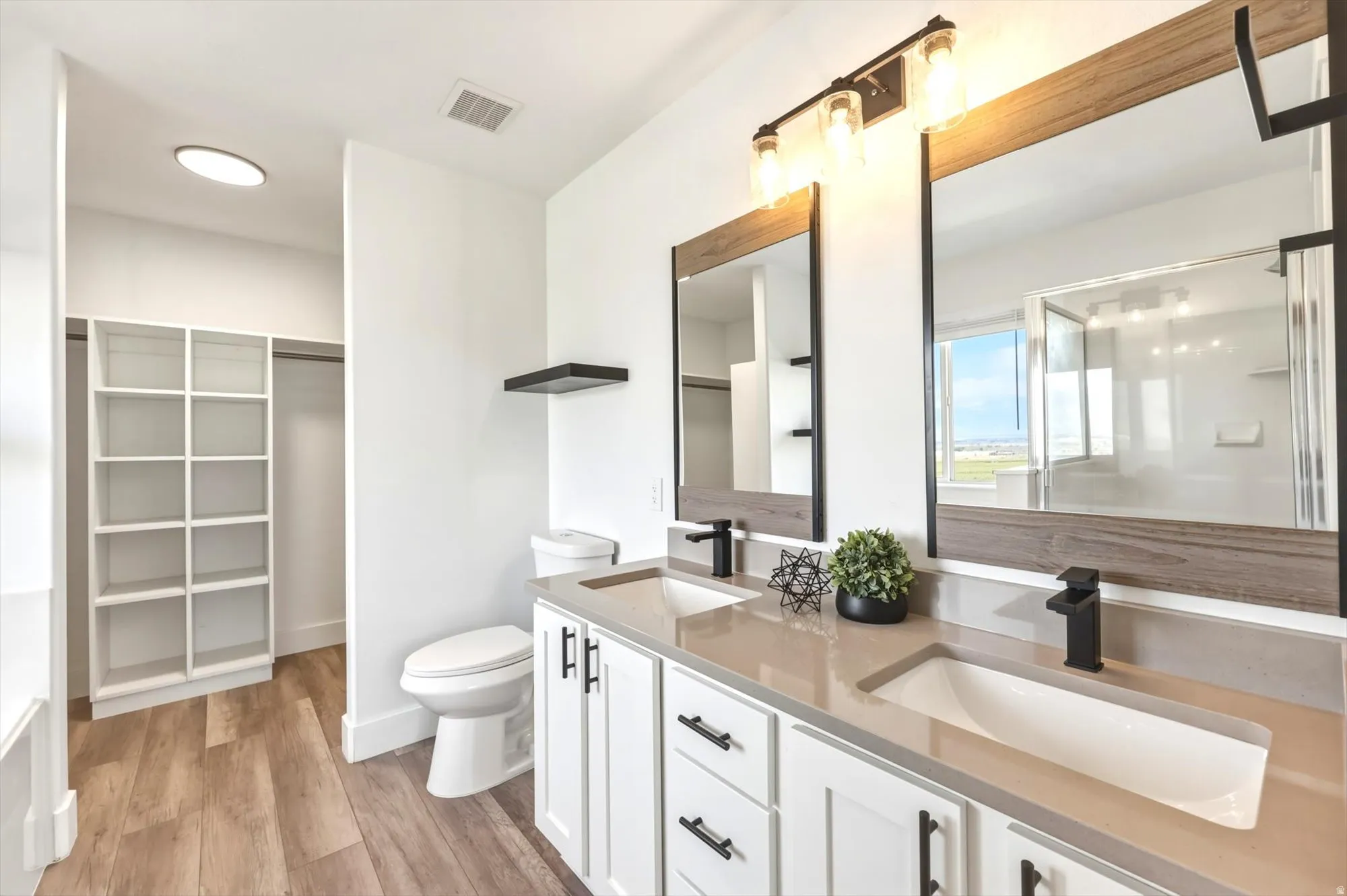 Dual vanity with integrated sinks, light-toned countertop, and matte black fixtures