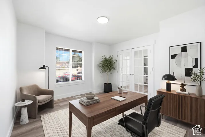 Bright room featuring wood-finish flooring and a white color palette