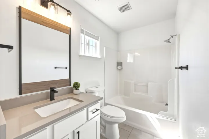 Modern bathroom featuring a quartz countertop vanity with an integrated sink and matte black faucet