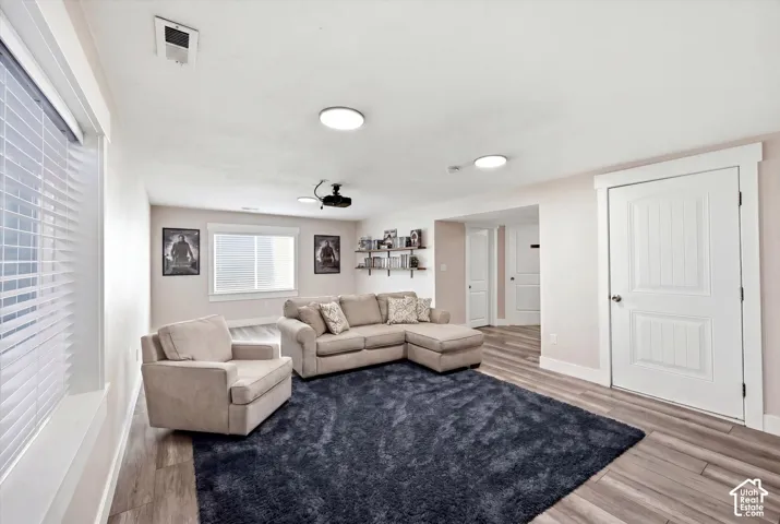 Living area featuring wood-finish flooring and recessed ceiling lights