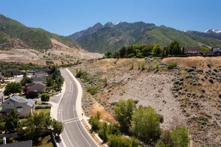Mountainous terrain surrounding a residential area with established homes
