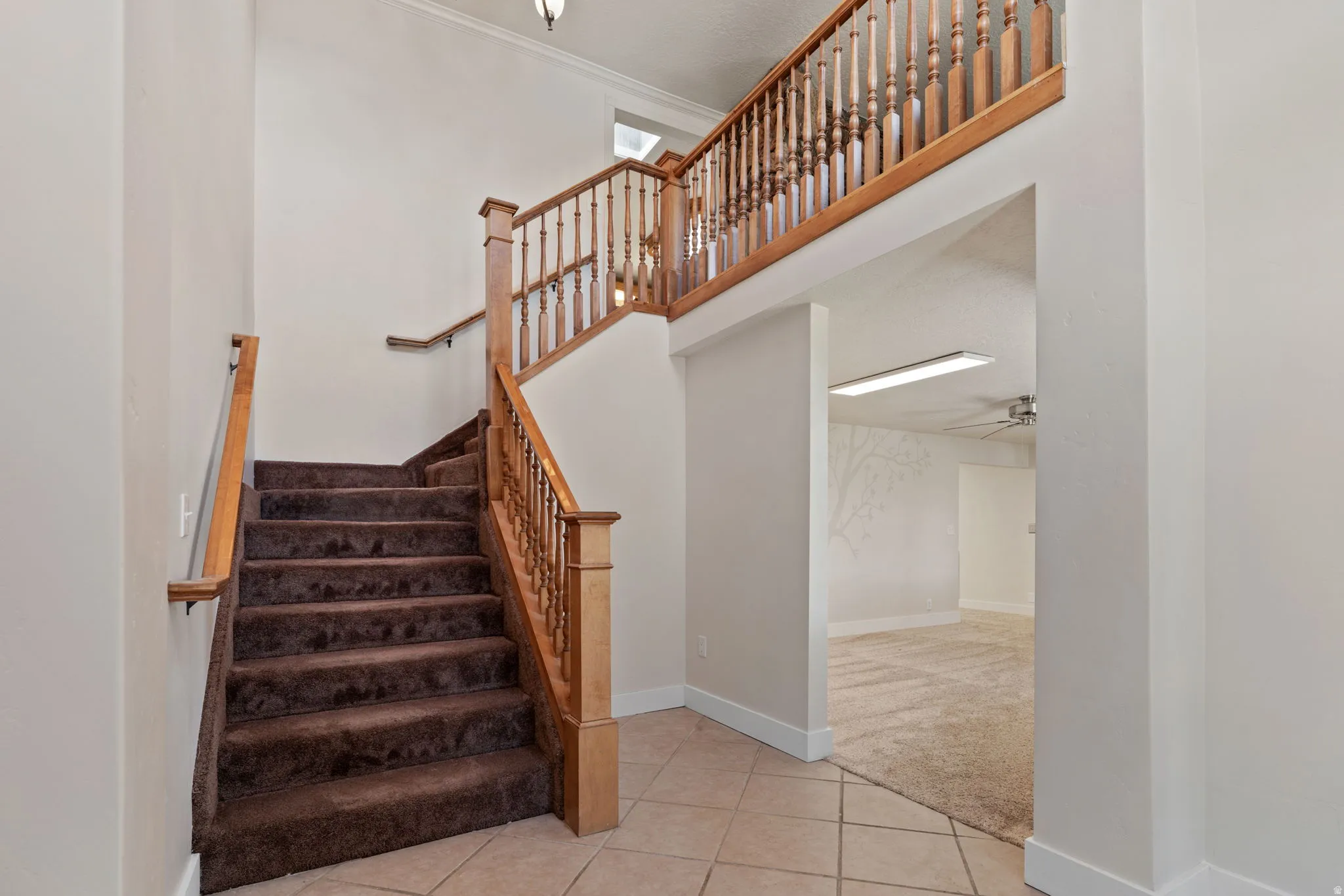 Grand entry staircase featuring a tiled landing