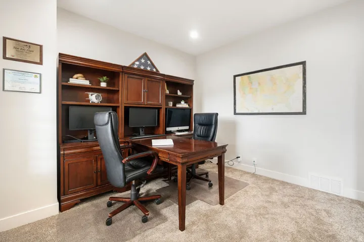 Built-in wood-finish cabinetry and shelving unit with integrated desk space