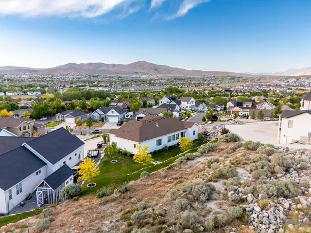 Elevated property offering a panoramic view of the surrounding residential area and distant mountains