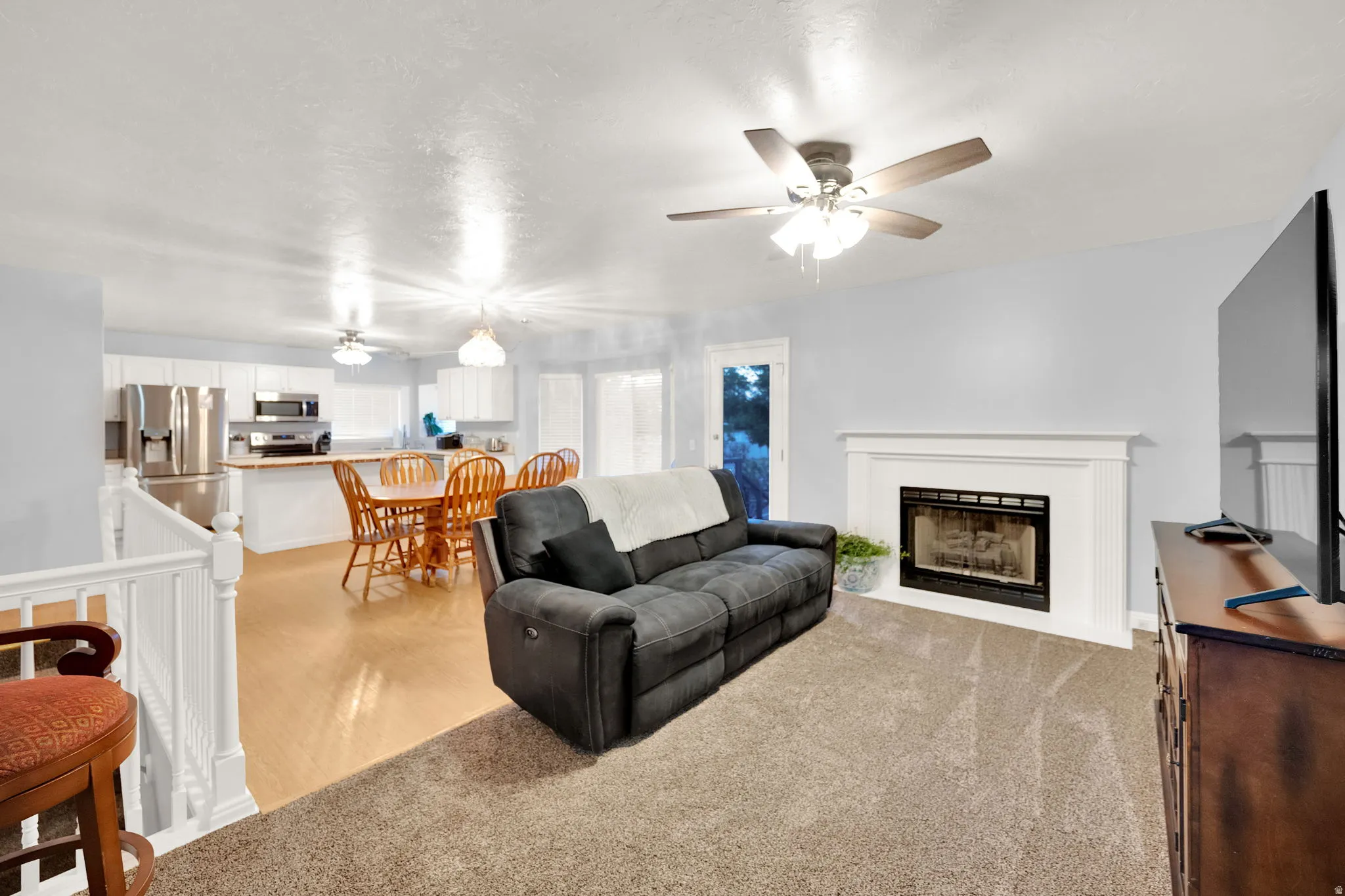 Living area featuring light-colored walls and a neutral carpet