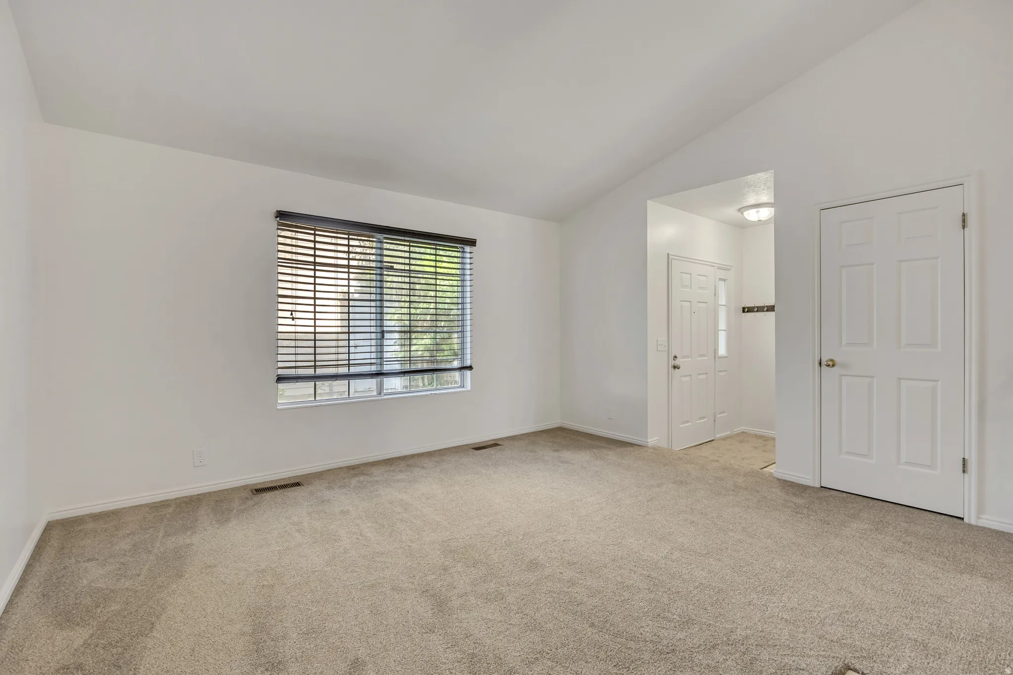 Spacious bedroom with neutral carpeting