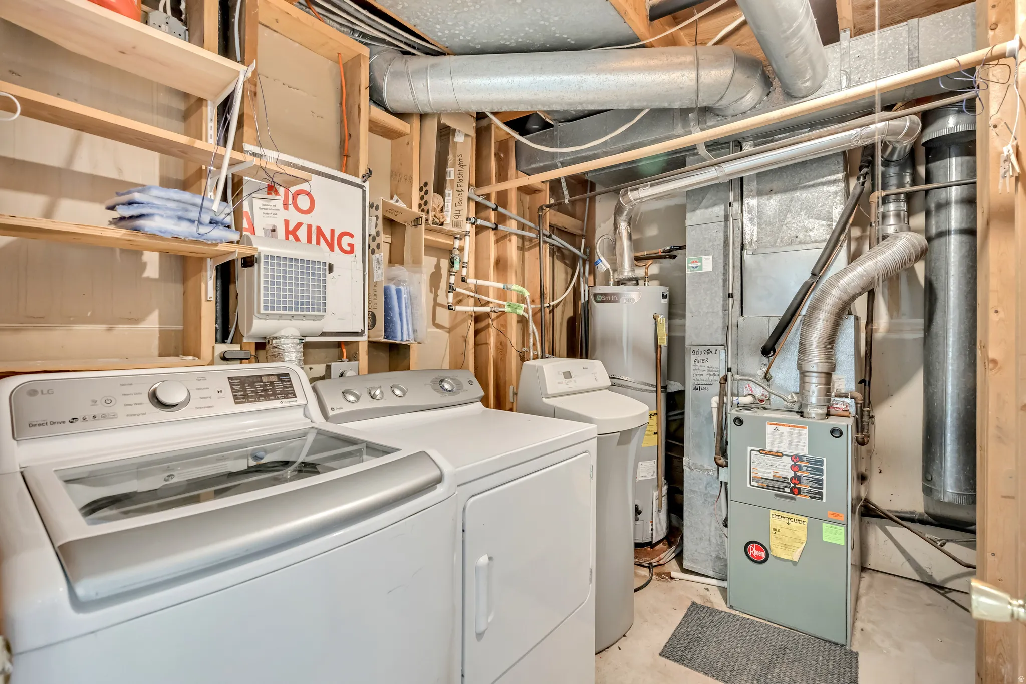 Laundry area with a top-load washer, front-load dryer, water heater, water softener, and furnace
