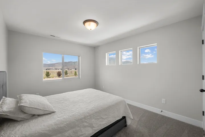 Room featuring a large picture window, three transom windows, and wall-to-wall carpeting