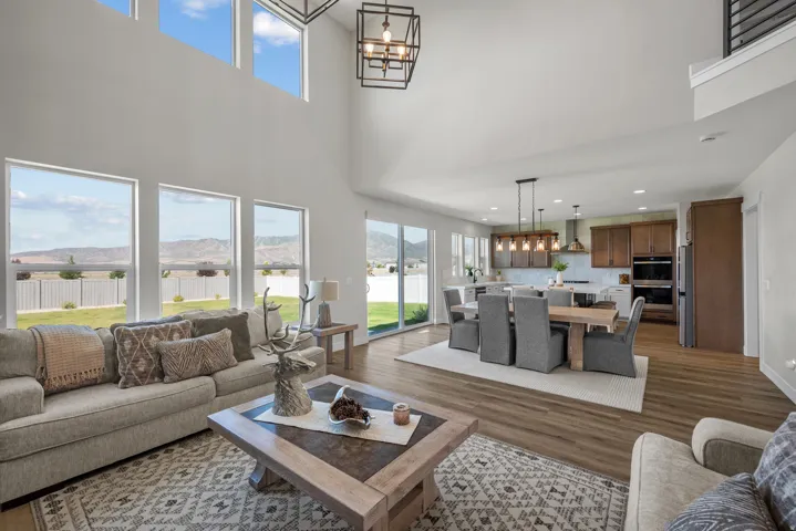 Open-concept living space featuring high ceilings and large windows