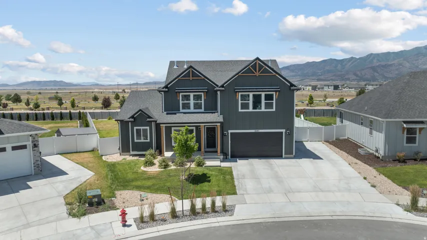 Modern two-story residence featuring dark siding with contrasting trim