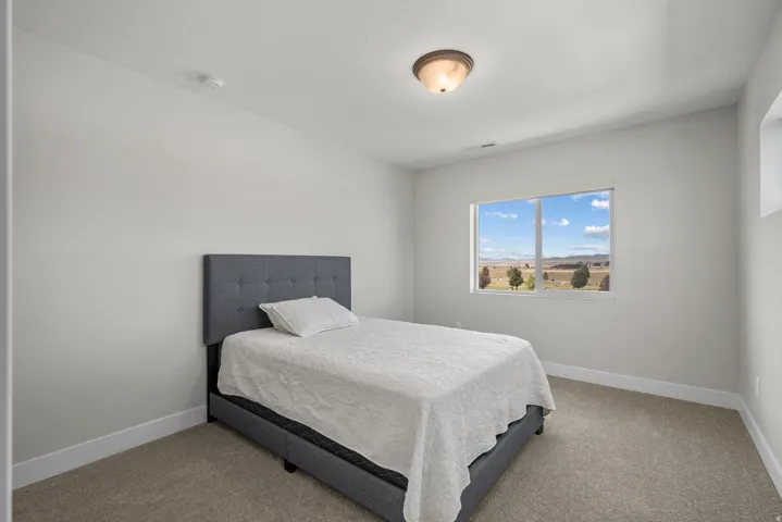 Neutral wall finishes complement the carpeted flooring