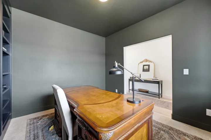 Office space featuring dark-painted walls and a coordinating ceiling
