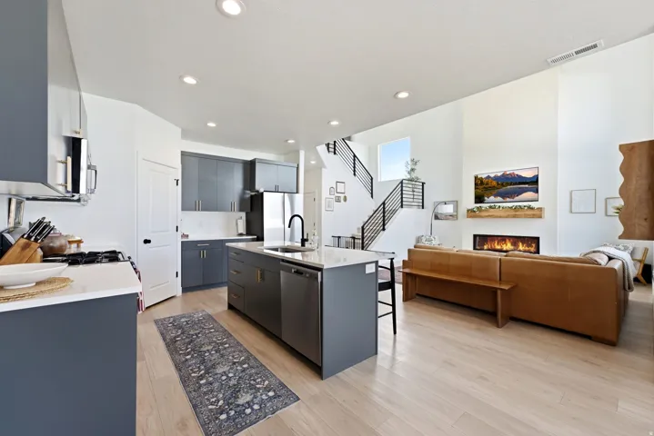 Open concept living space featuring wood-finish flooring