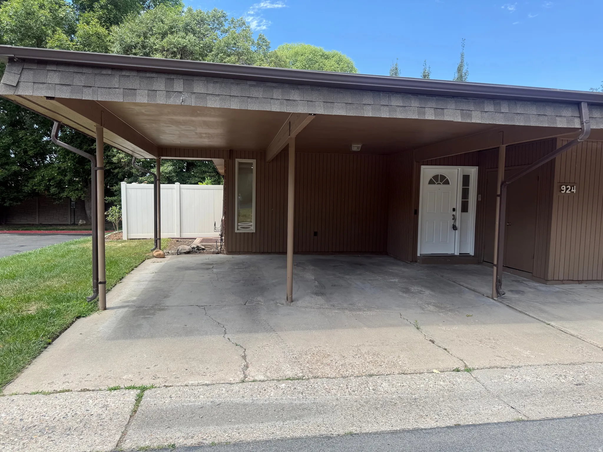 Covered carport with asphalt shingle roof