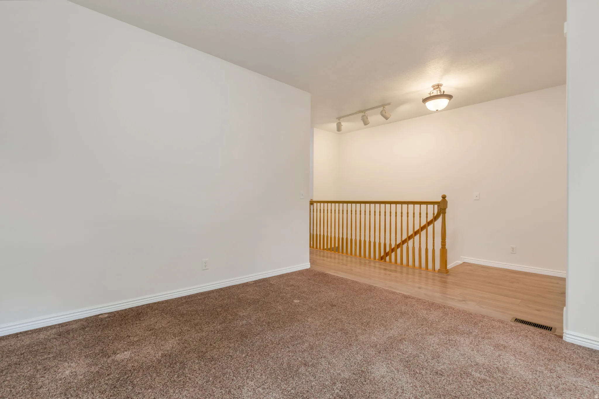 Expansive carpeted area with neutral wall tones
