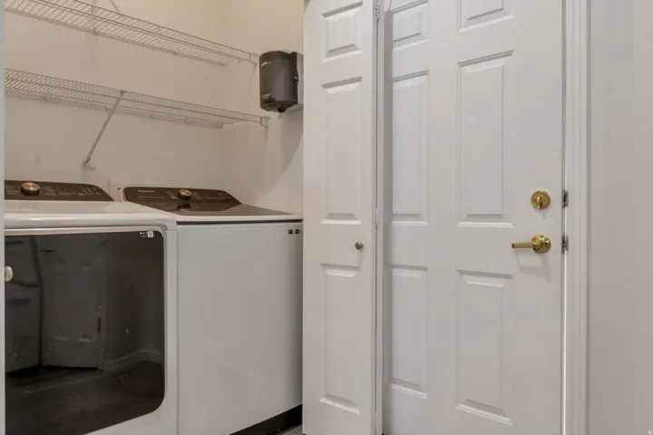 Utility area featuring shelves. Laundry room is immediate from garage entry