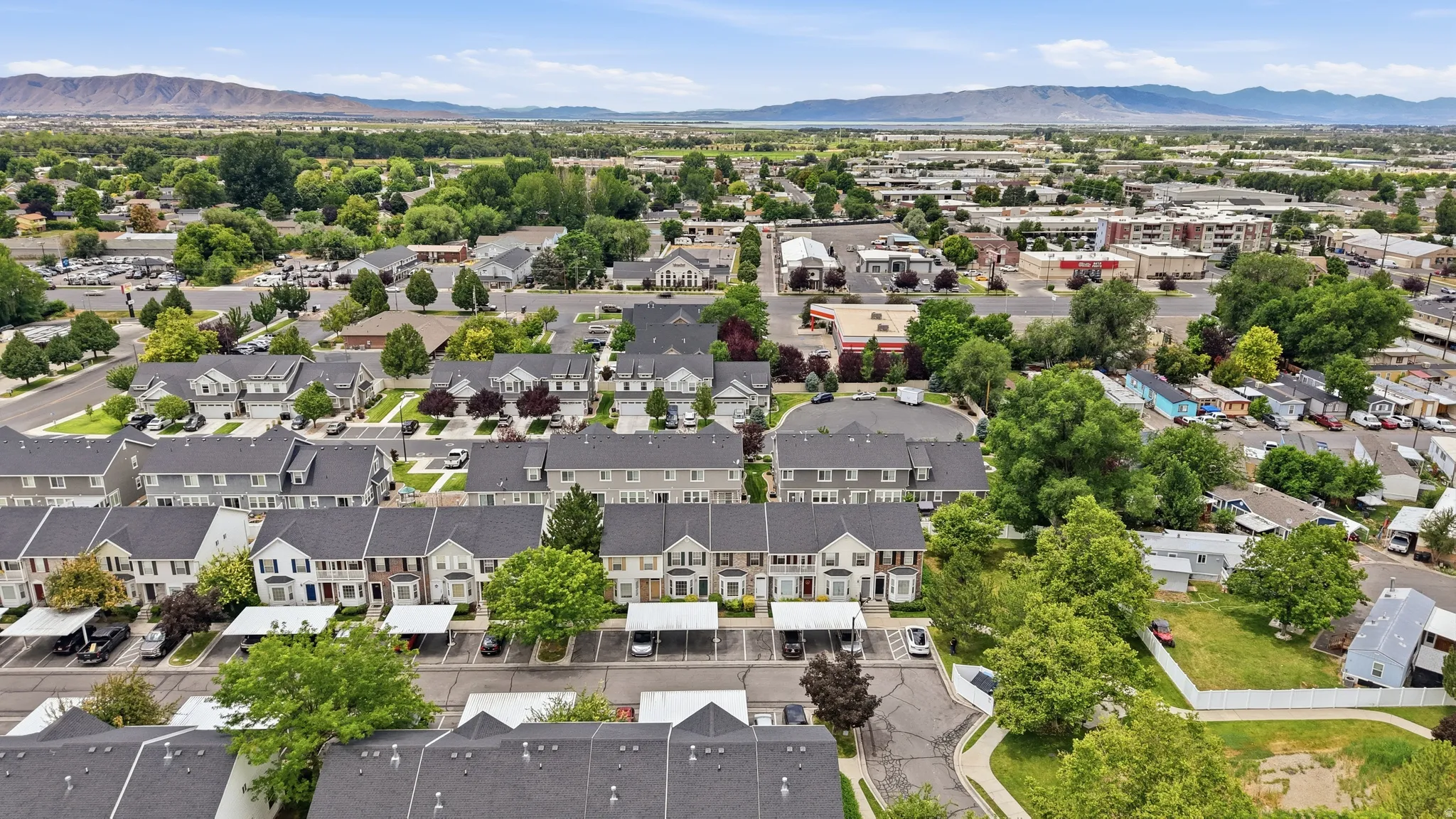 Aerial perspective showcasing a residential community with townhomes and detached properties