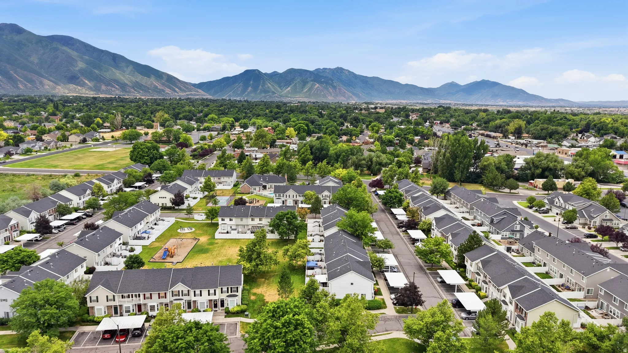 Aerial perspective showcasing a residential community with townhouses and green spaces