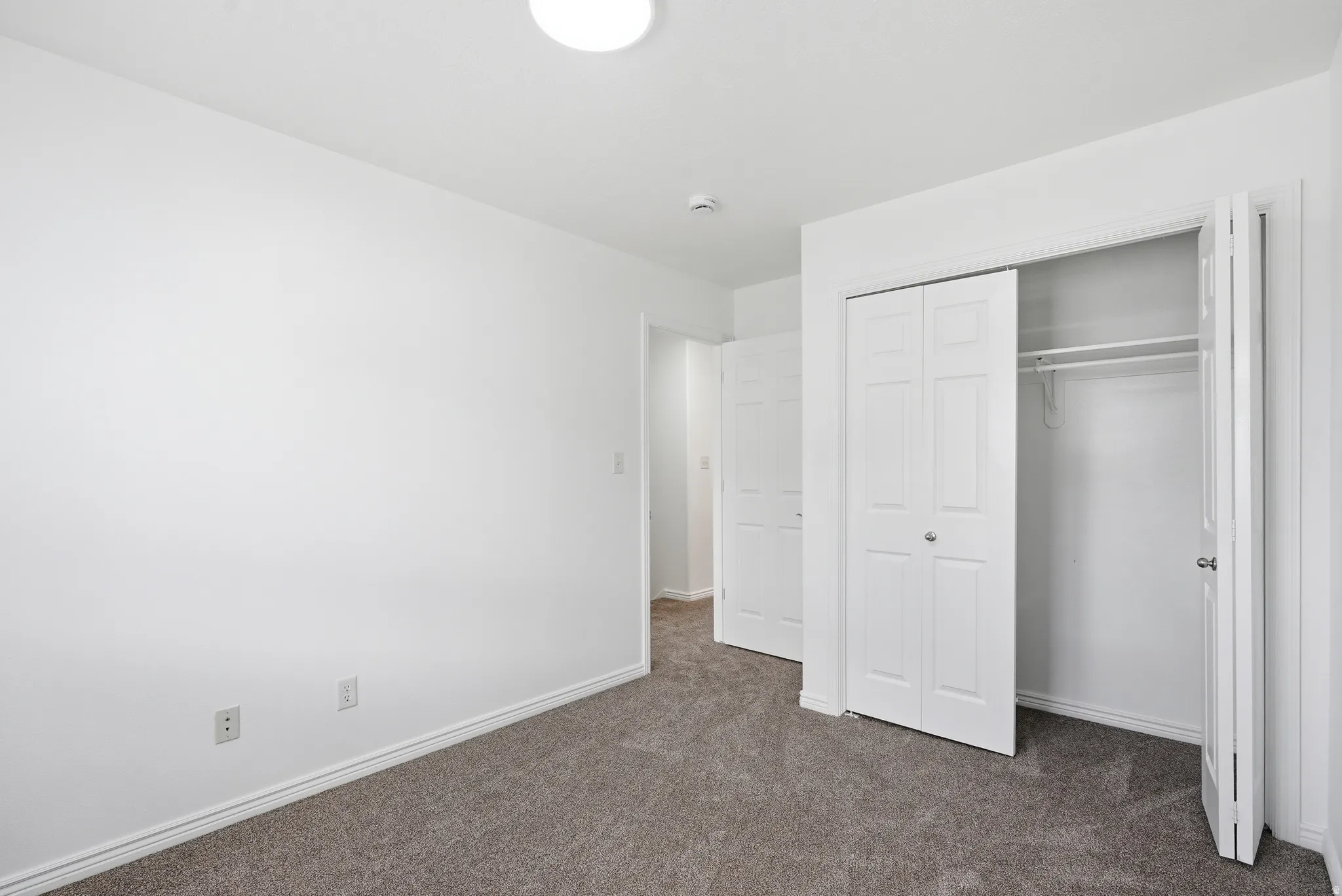 Neutral gray carpet flooring complements white painted walls and trim