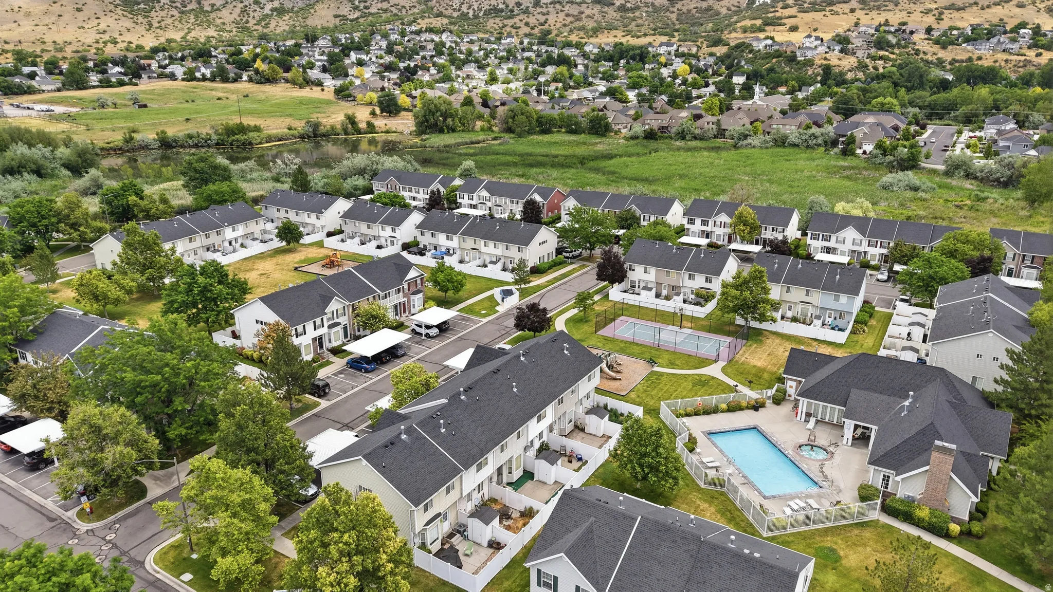 Aerial perspective showcasing a residential community with numerous townhome-style properties