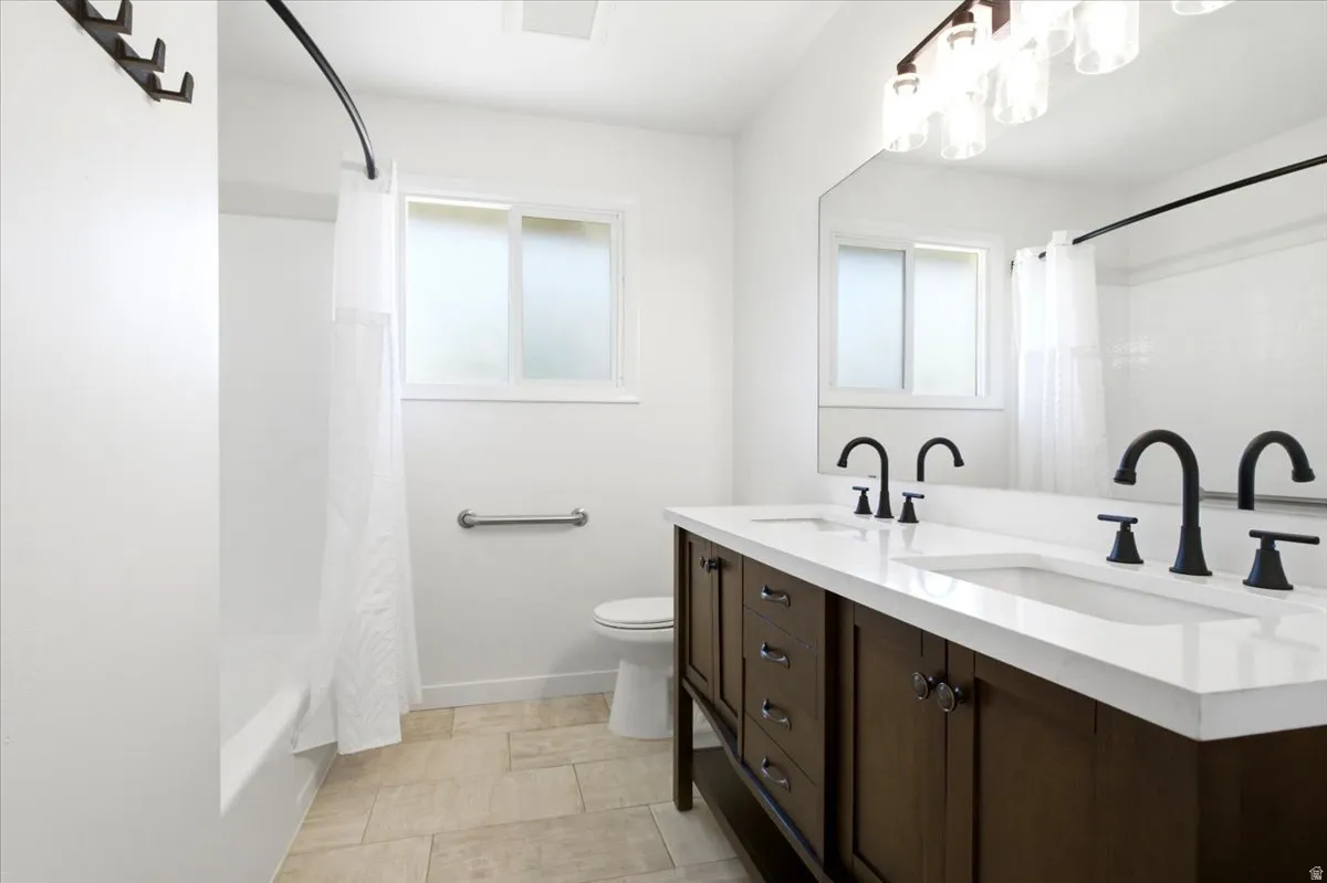 Double vanity with a white countertop and matte black faucets