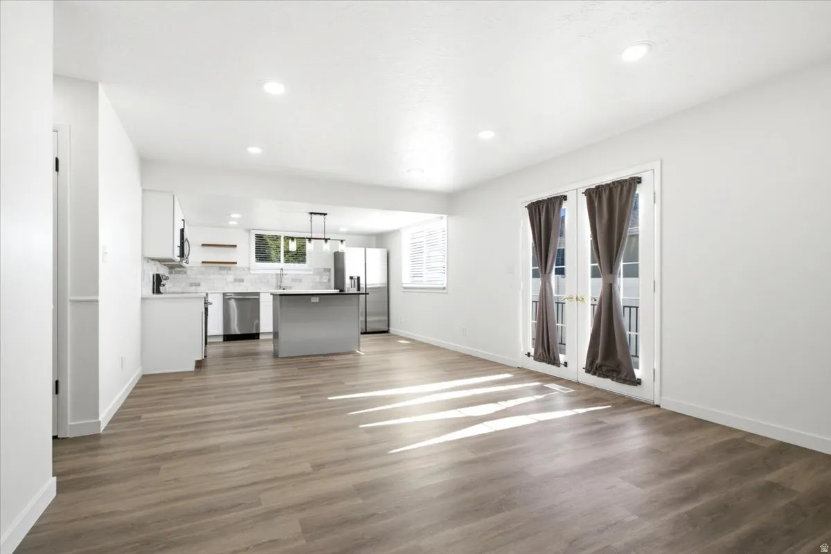 Open-concept living space with wood-finish flooring and recessed lighting