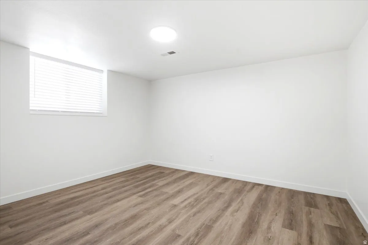 Bright room featuring wood-finish flooring and a white color palette
