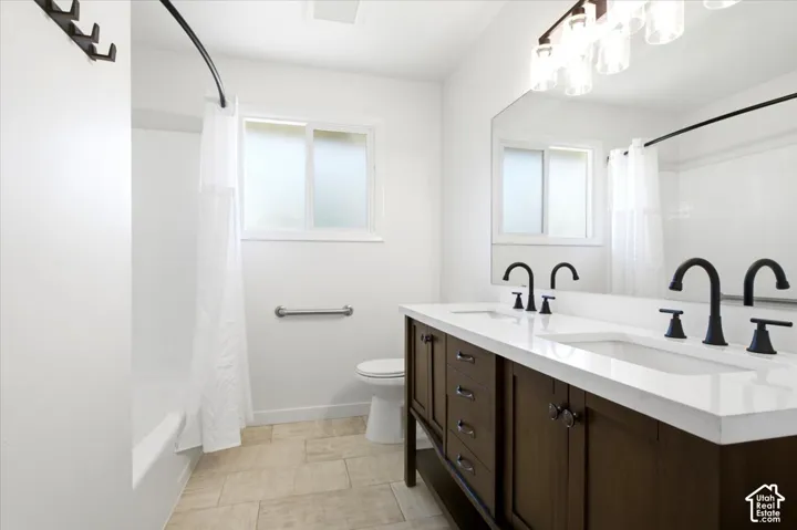 Double vanity with a white countertop and matte black faucets