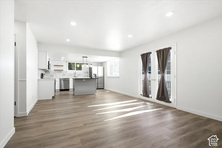 Open-concept living space with wood-finish flooring and recessed lighting