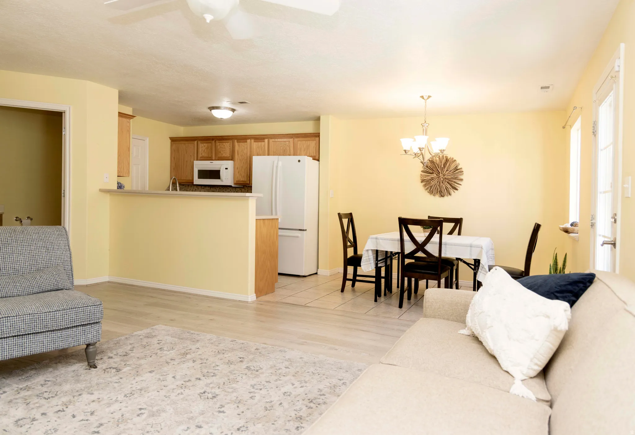 Open-concept living area featuring wood-finish flooring and a ceiling fan