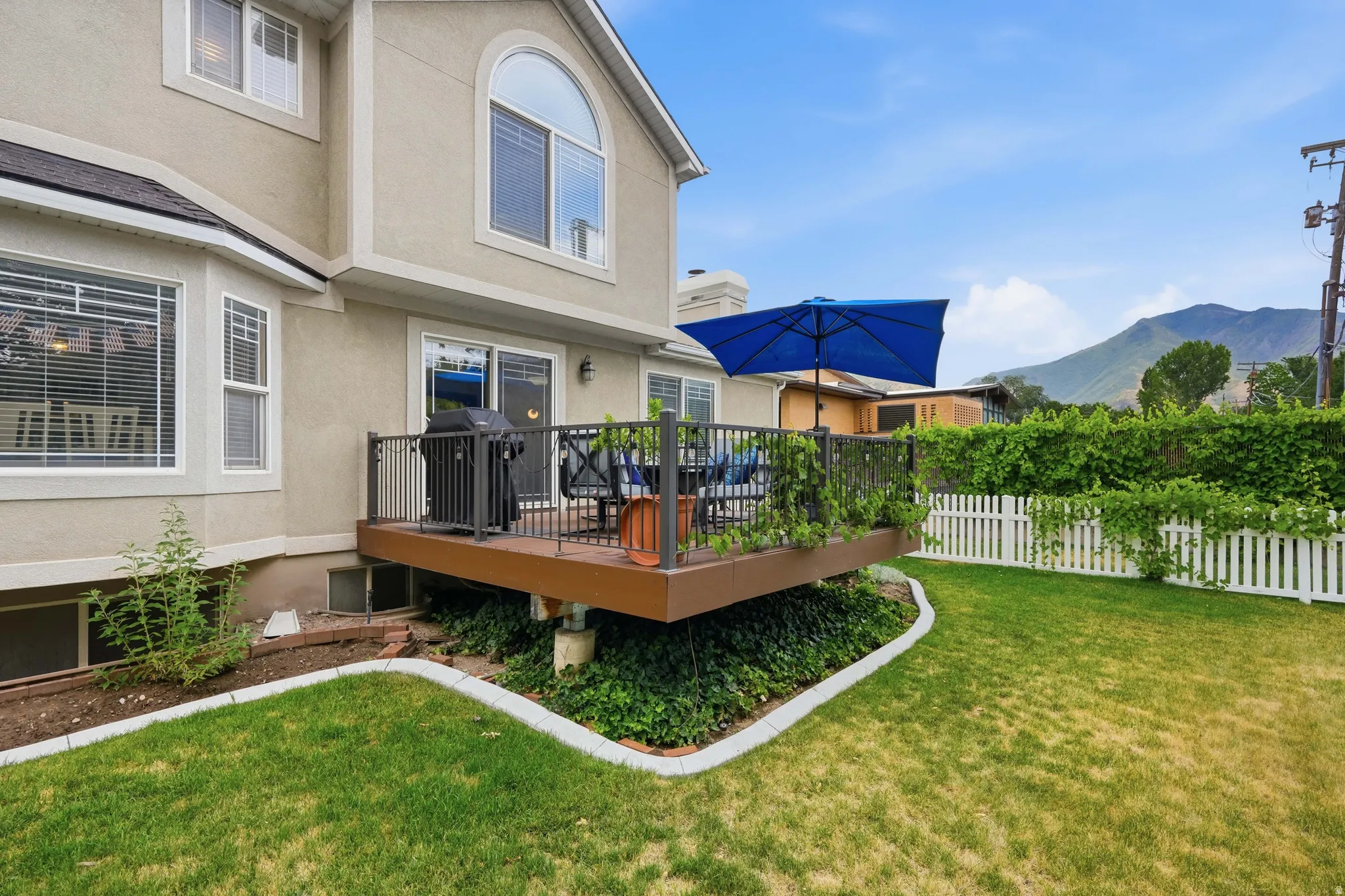 Elevated deck featuring dark railings and a sliding glass door entry