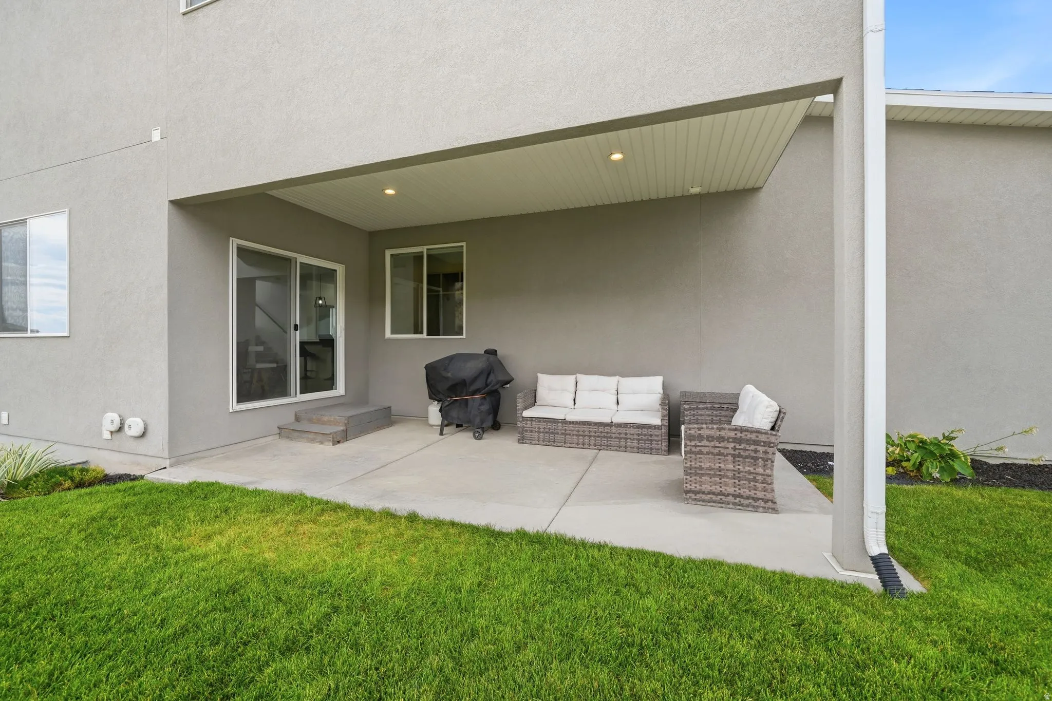 Expansive covered patio featuring recessed lighting, a concrete surface, and a sliding glass door entry