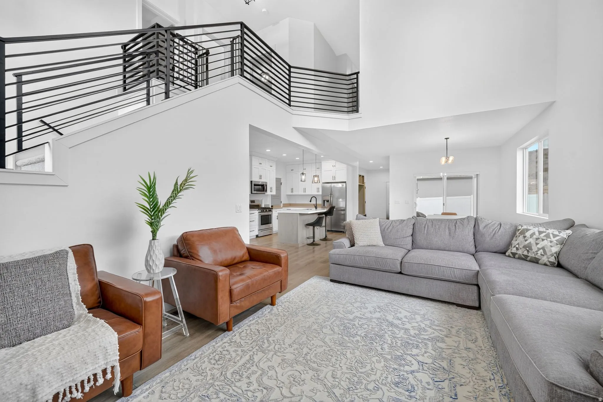 Open-concept living space with high ceilings and light wood-finish flooring
