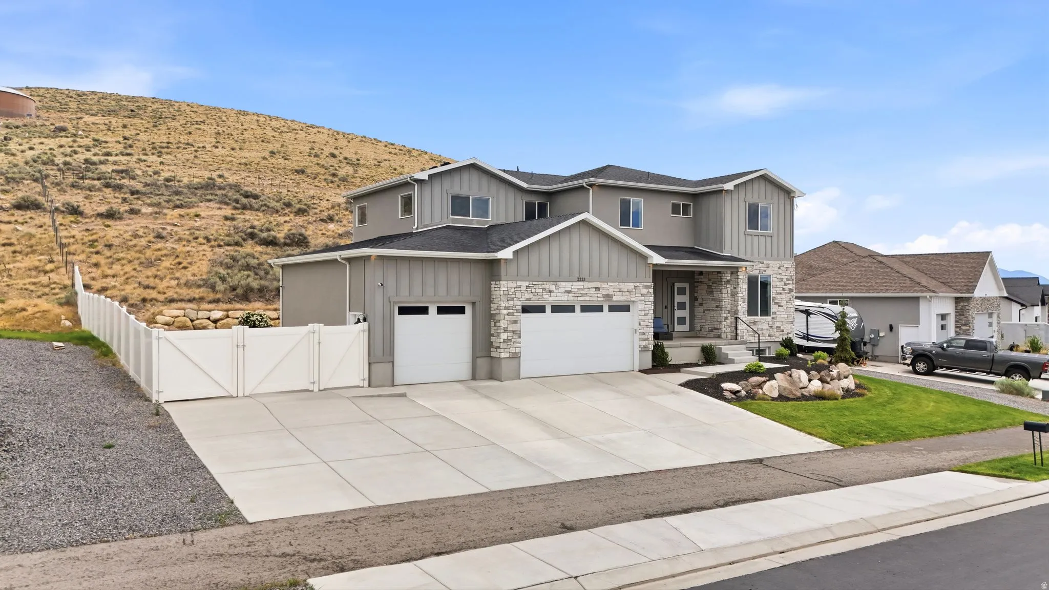 Modern two-story residence featuring a combination of stone and vertical siding