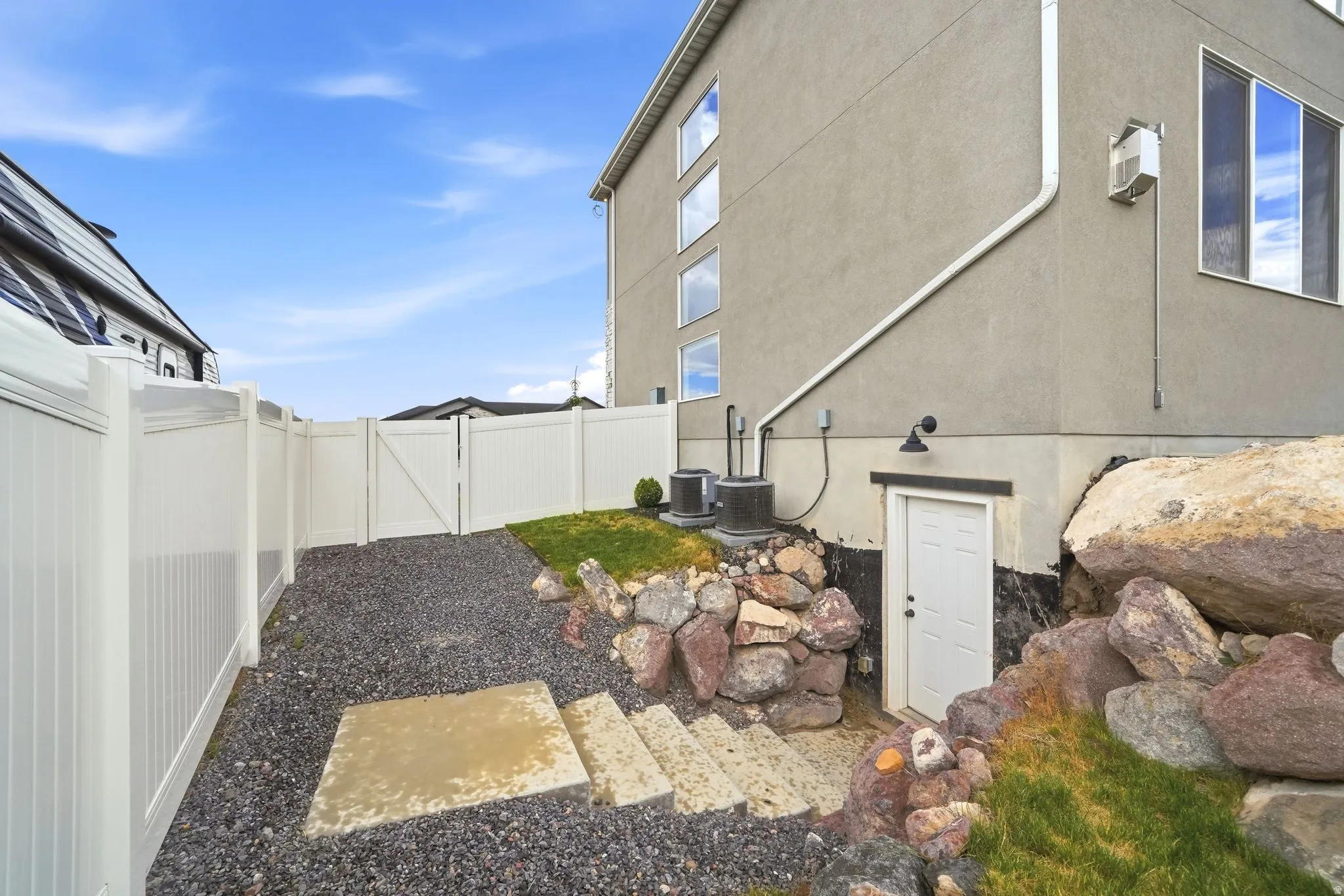 Full privacy fencing enclosing a gravel pathway