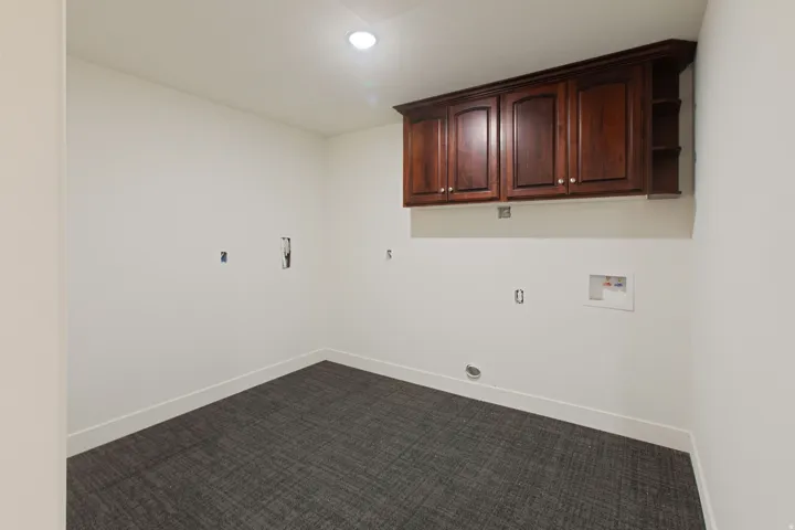 Recessed lighting illuminates this space featuring wall-mounted cabinetry with integrated open shelving