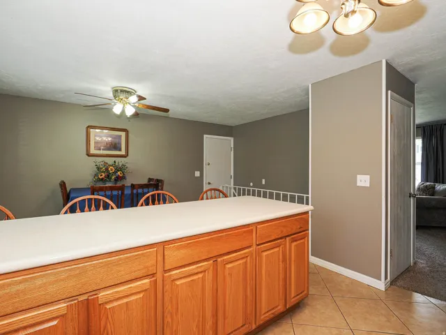 Kitchen island featuring light wood cabinetry and a light-toned countertop