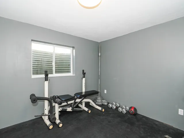 Room featuring grey walls, a single window, and a flush-mount ceiling light