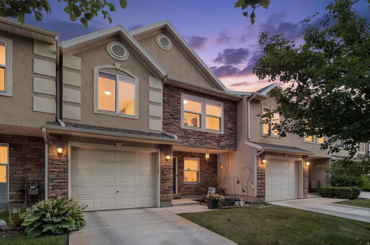 Two-story townhouse exterior with stone veneer and stucco facade
