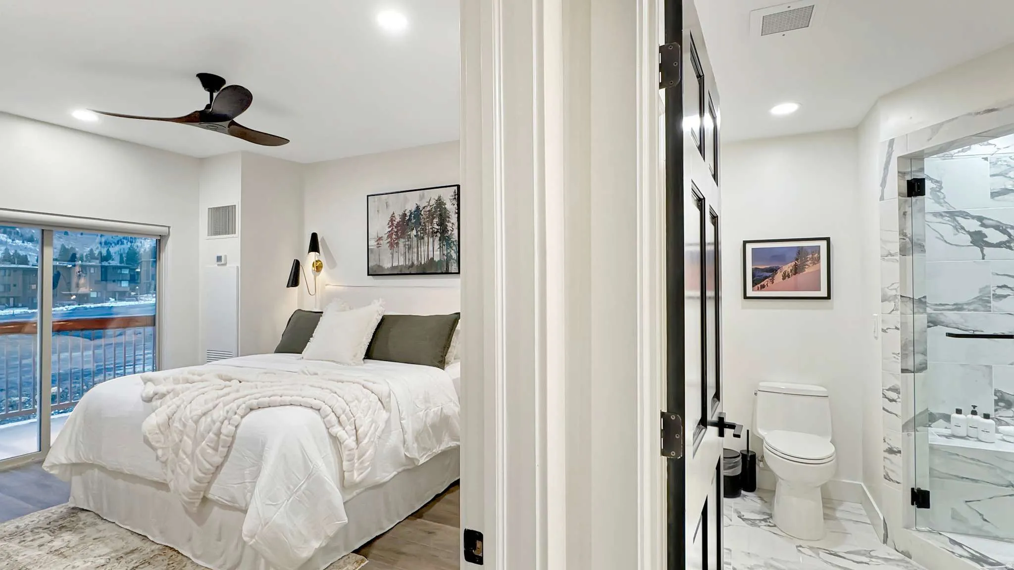 Bedroom featuring a sliding glass door to a balcony, wood-finish flooring, and a ceiling fan