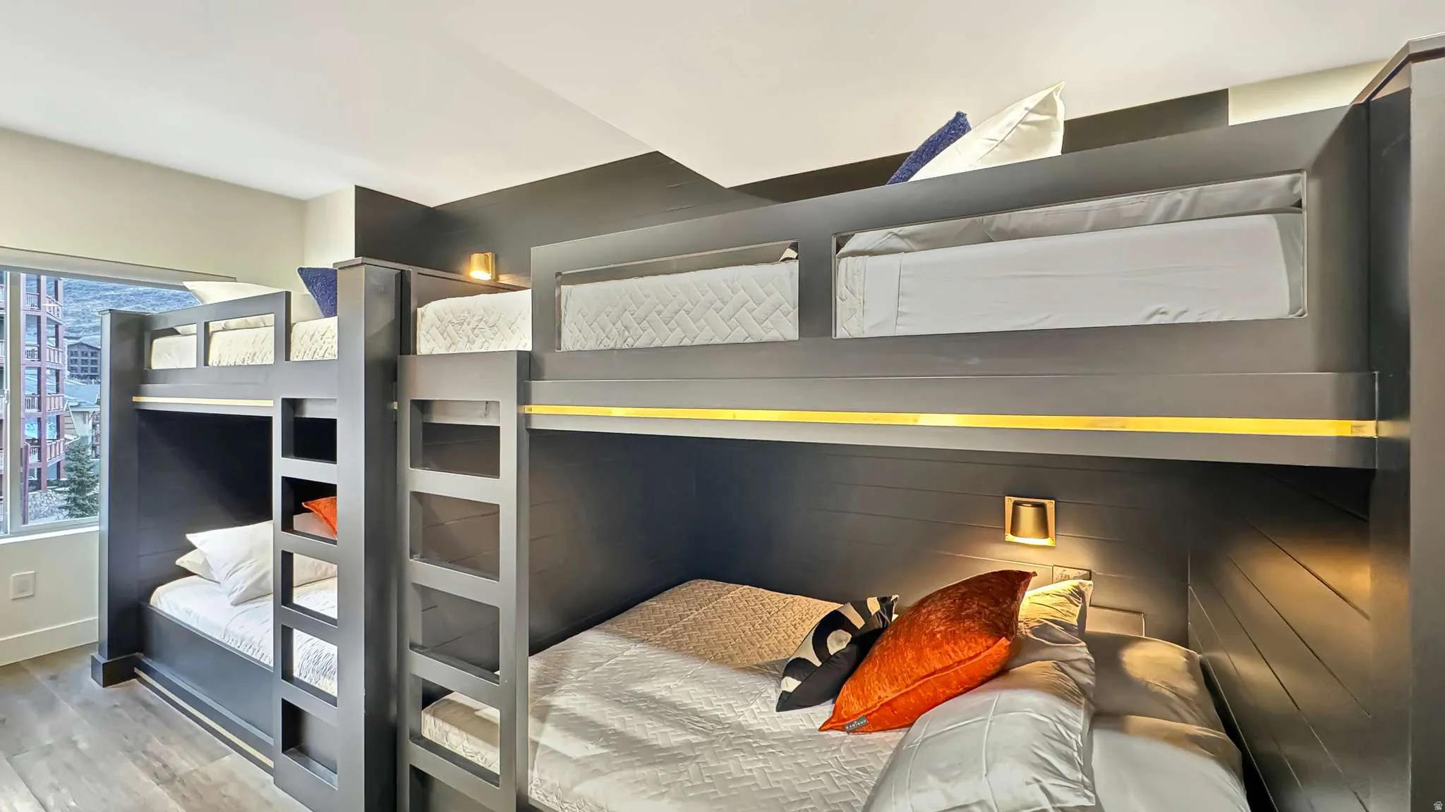 Built-in bunk beds with integrated ladders and individual lighting fixtures