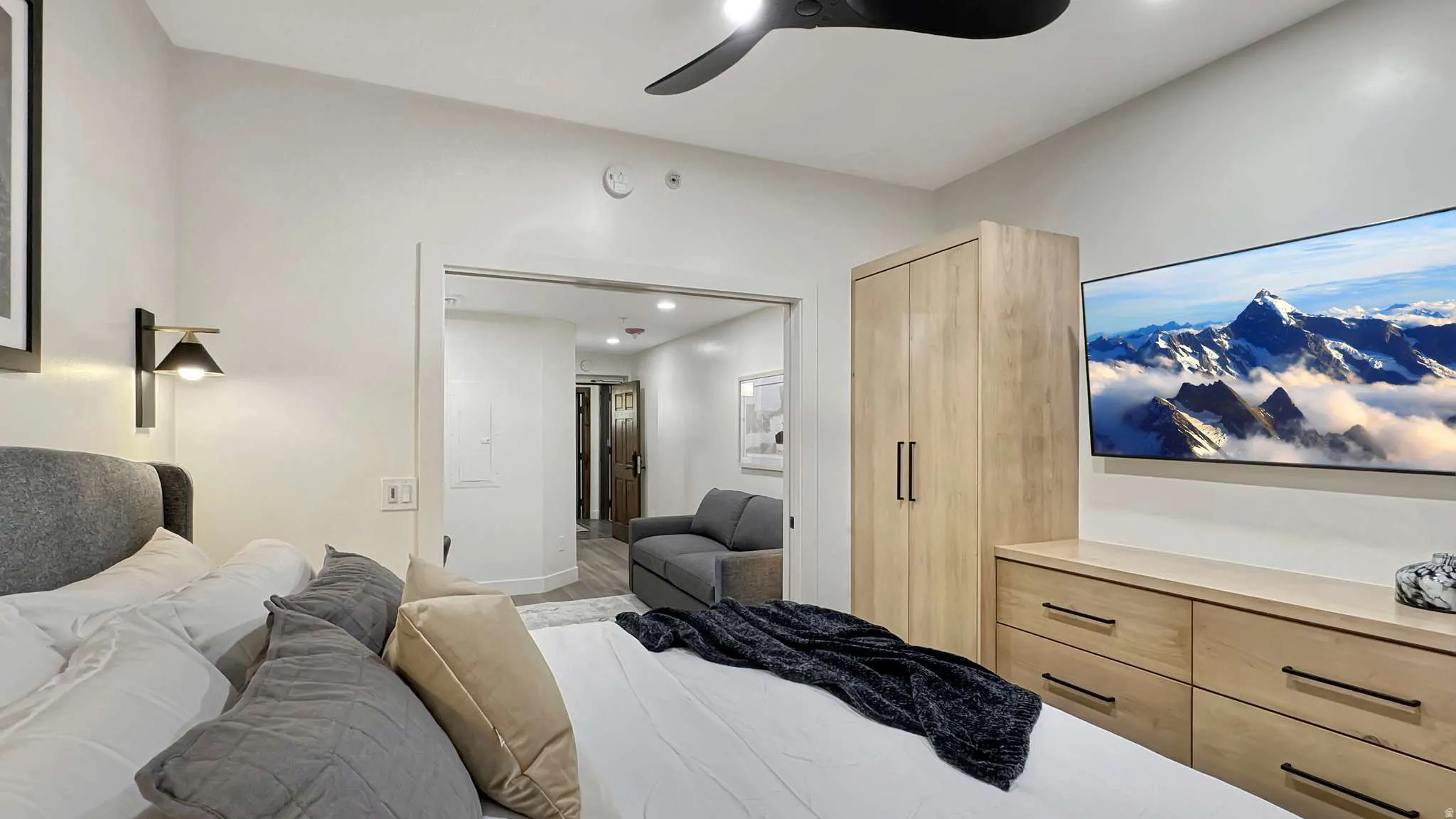 Recessed lighting with a ceiling fan, light wood-finish built-in wardrobe, and matching dresser cabinetry