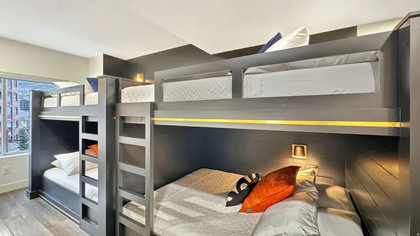 Built-in bunk beds with integrated ladders and individual lighting fixtures