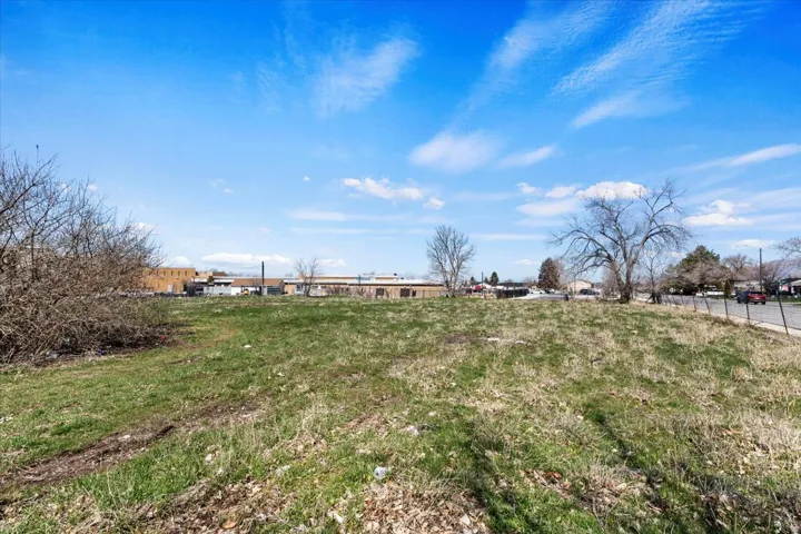 Expansive, level land parcel featuring existing natural ground cover