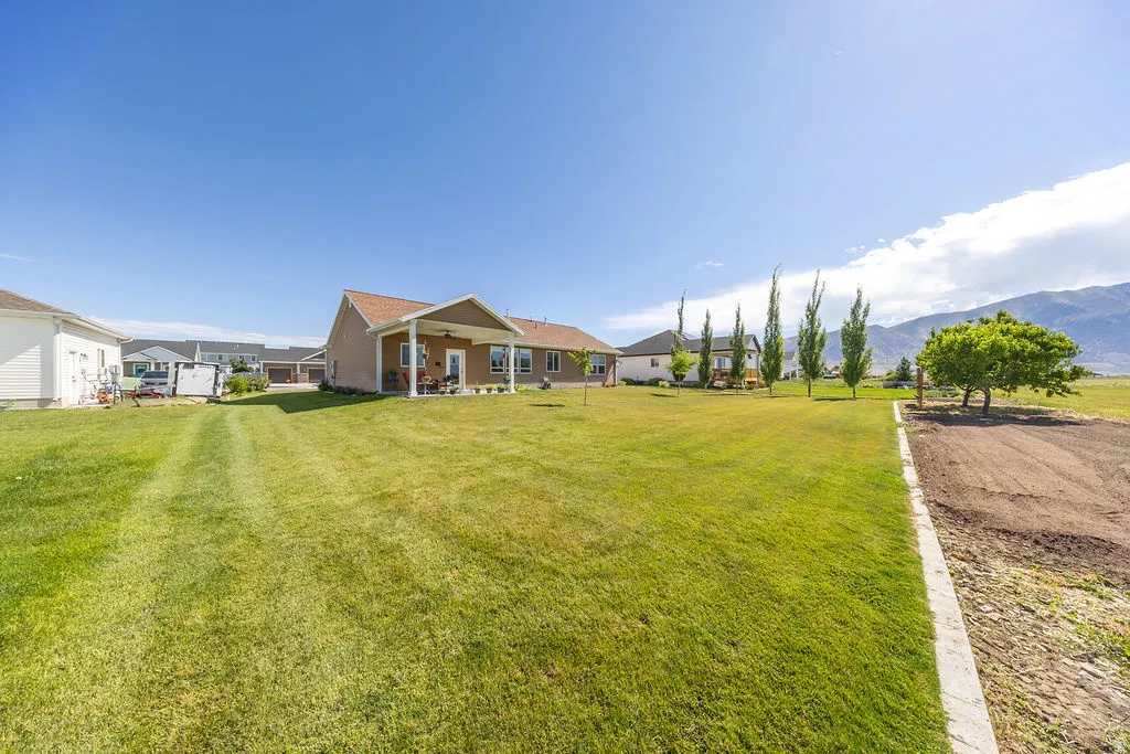 Expansive grass lawn extending to a mountain backdrop