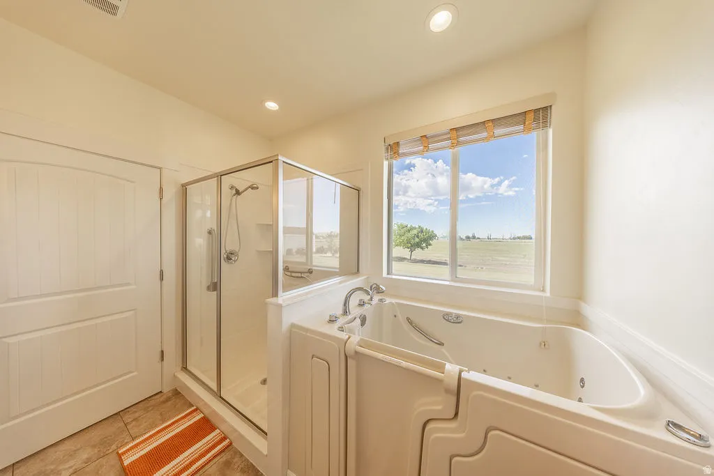 Walk-in tub with jets and window with exterior scenery