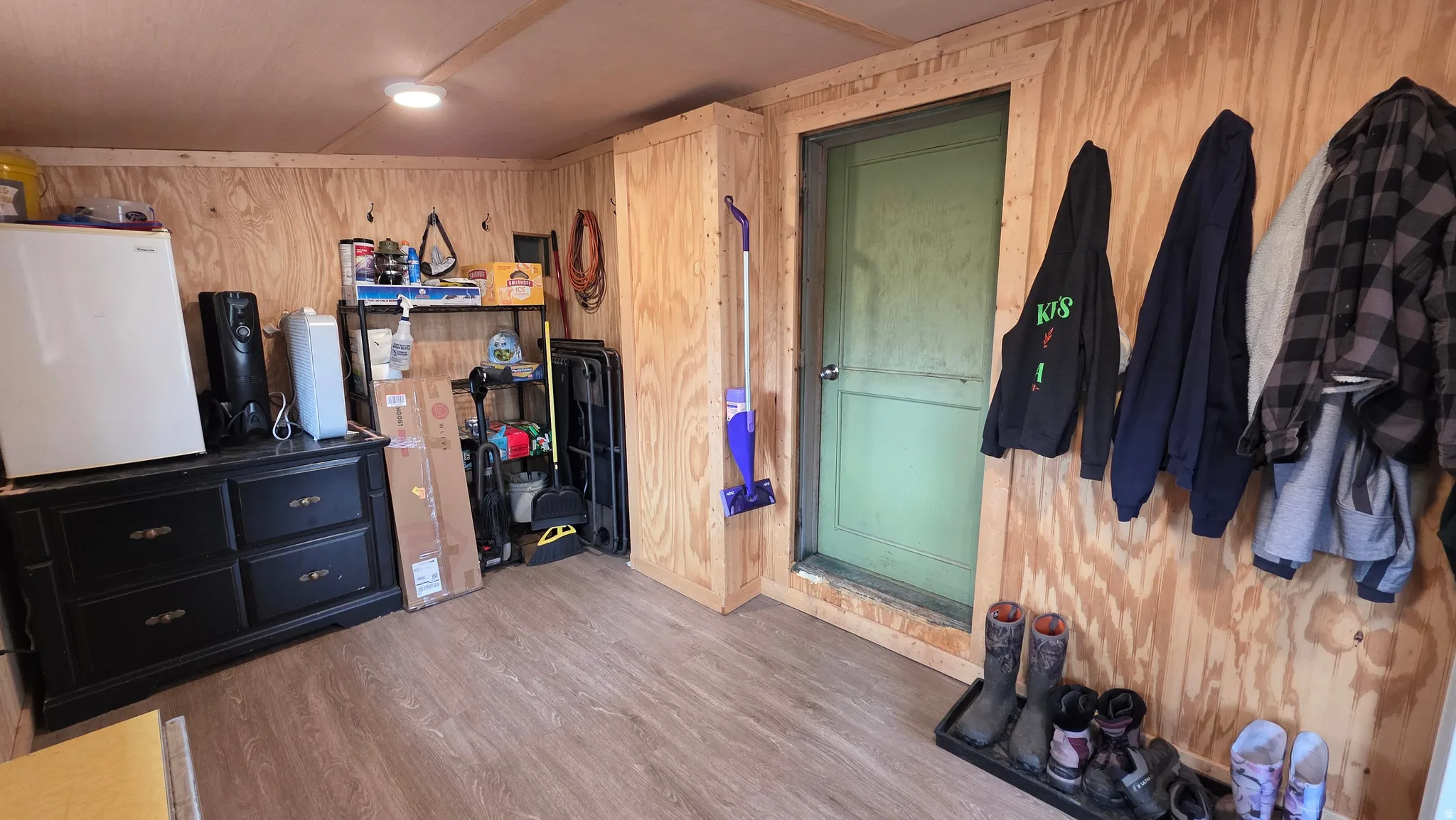 Interior space featuring wood-finish wall panels and complementary wood-finish flooring