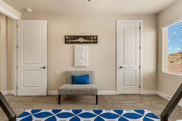 Neutral-toned walls complement the textured carpet flooring